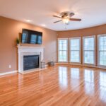 Empty Living Room with No Furniture and Wooden Floors and Fireplace