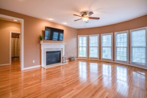 Empty Living Room with No Furniture and Wooden Floors and Fireplace